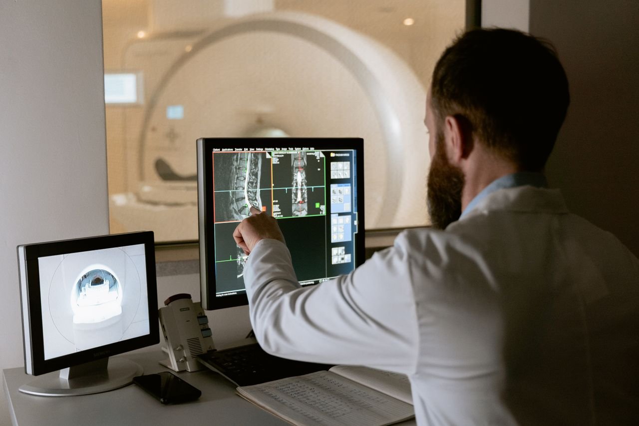 The Art of Drawing Readers In: Your attractive post title goes here Medical professional reviewing MRI scans on computer screens for diagnostic purposes.